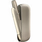 Gold IQOS device in open matching charging case showing holder partially lifted.
