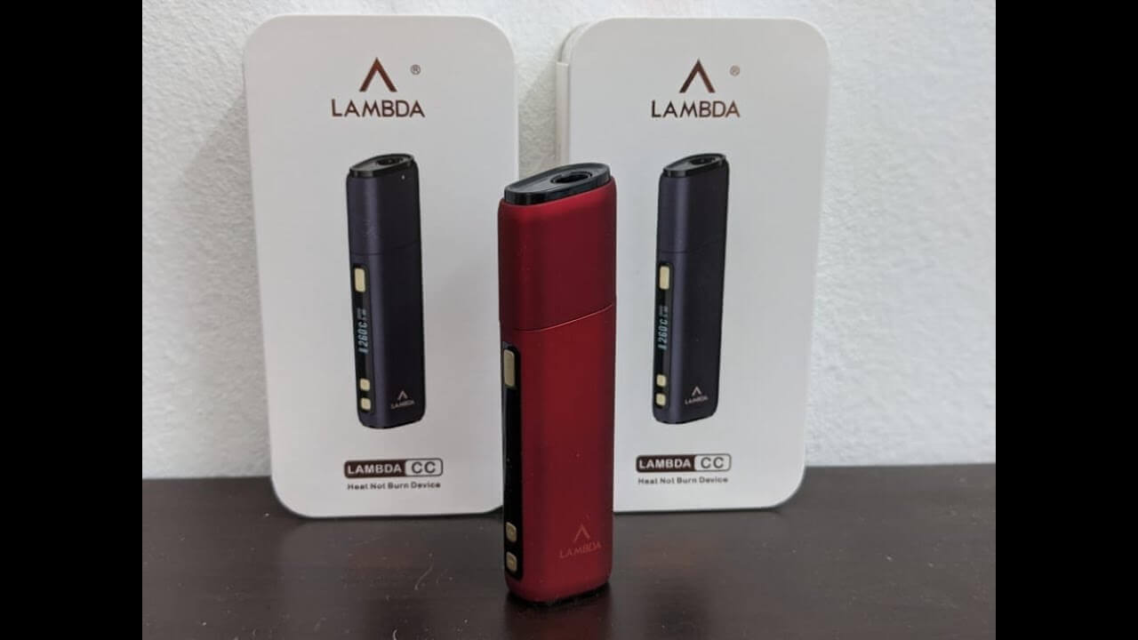 Red LAMBDA CC device standing before two product boxes with black devices.